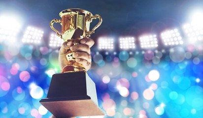 Man holding an award tile